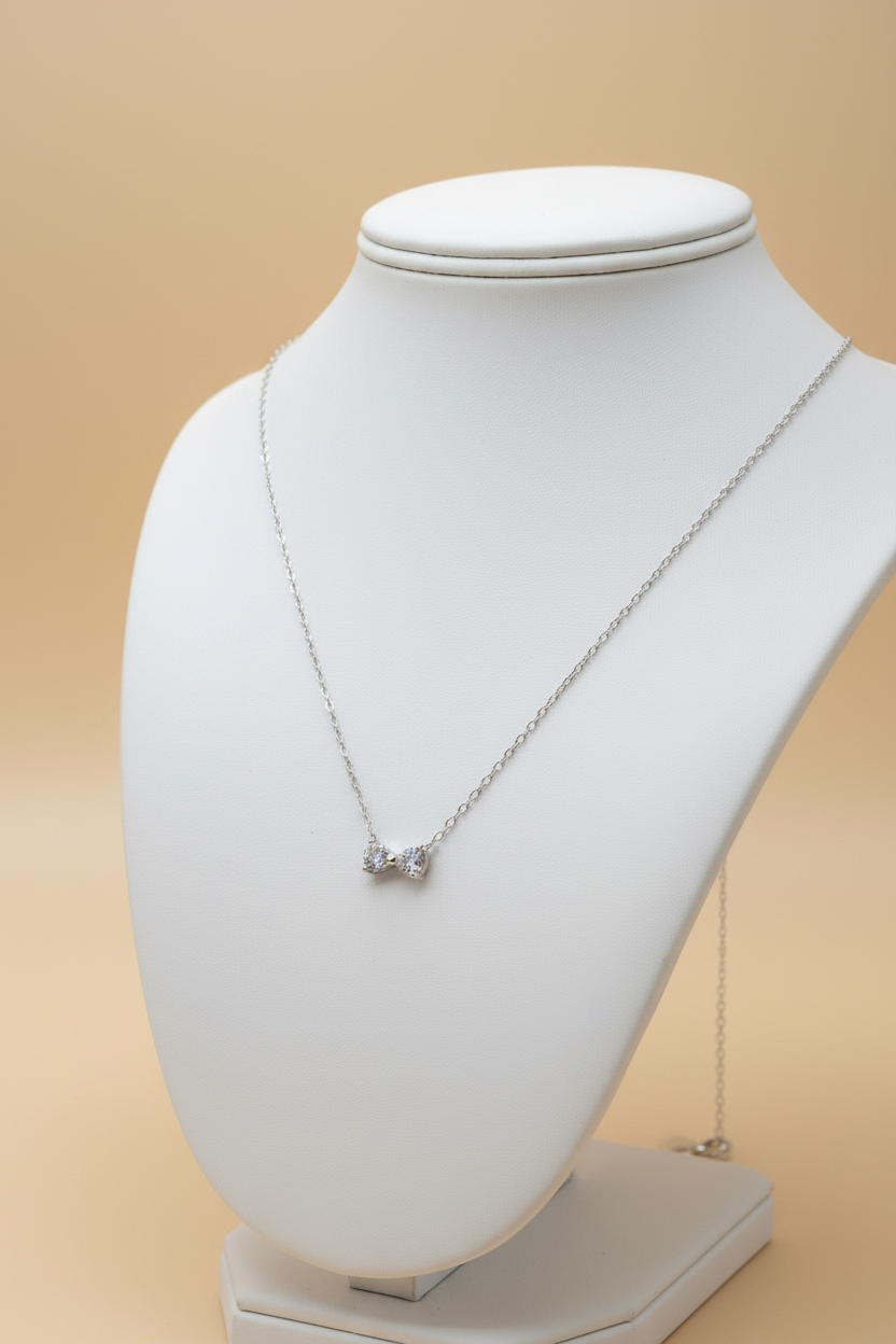 Crystal bow necklace on stand