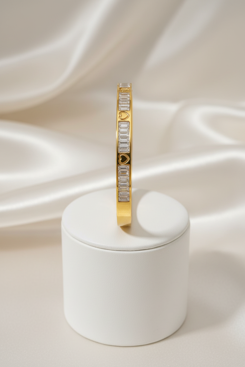Gold baguette heart bangle on stand