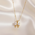Gold bow necklace champagne satin background
