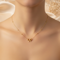 Gold Bow Necklace on Neck