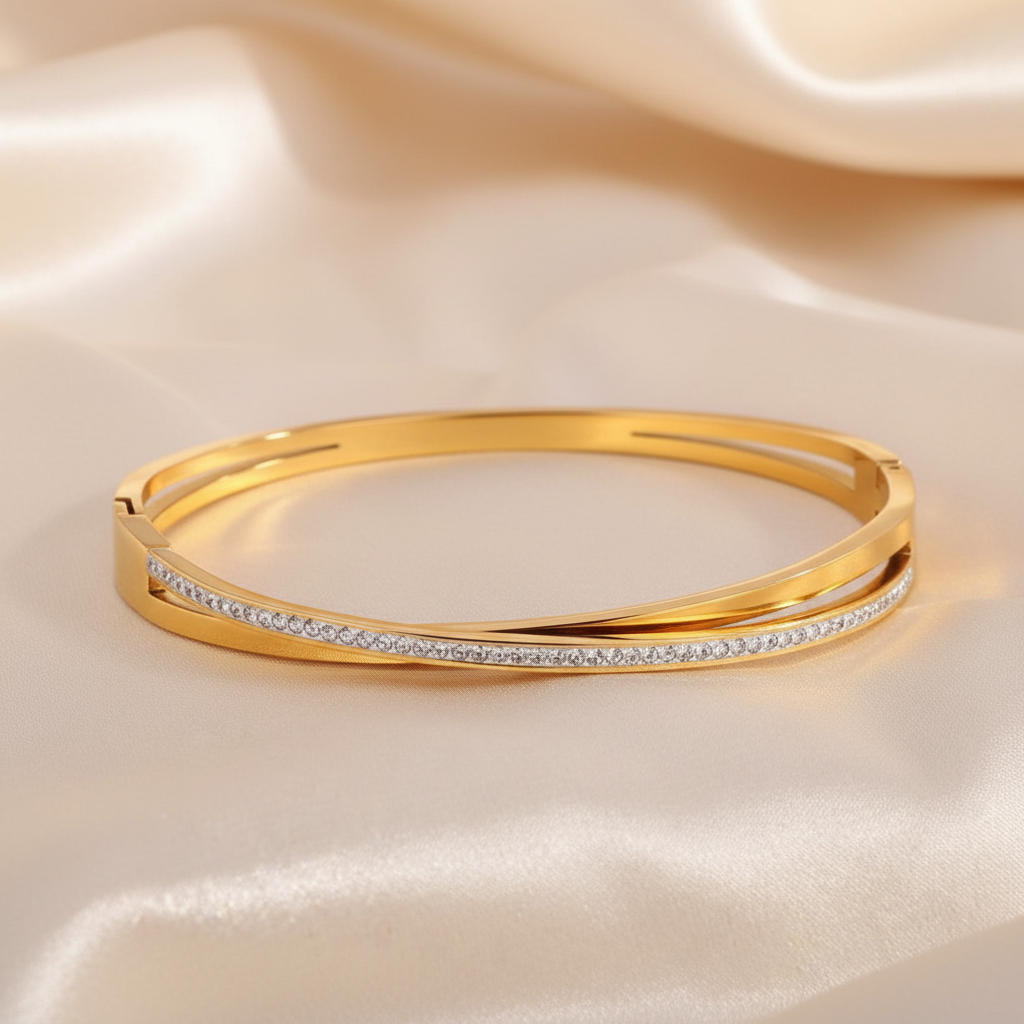 Gold Crossover Bangle - Champagne Satin Background