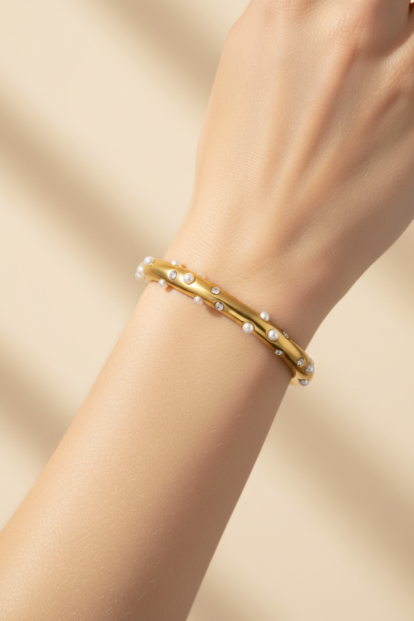 Gold crystal cuff bangle on wrist