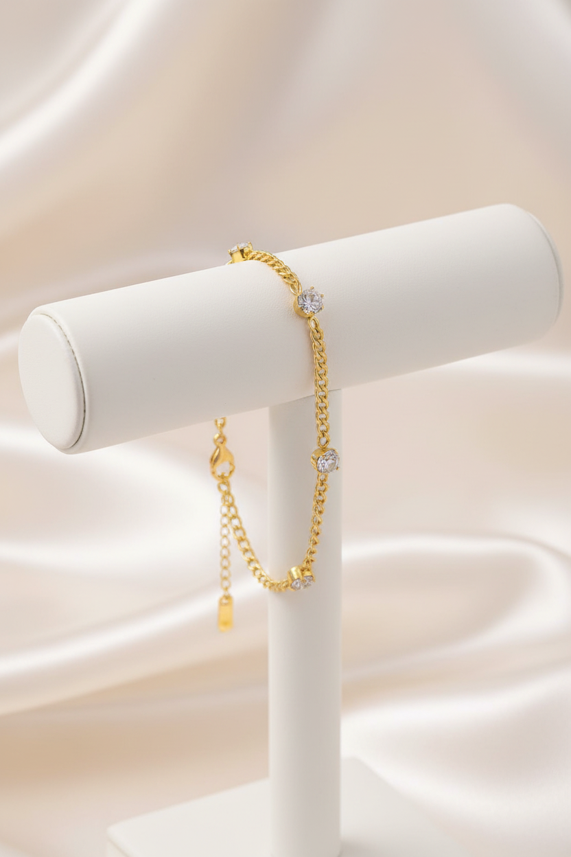 Gold curb crystal bracelet on stand