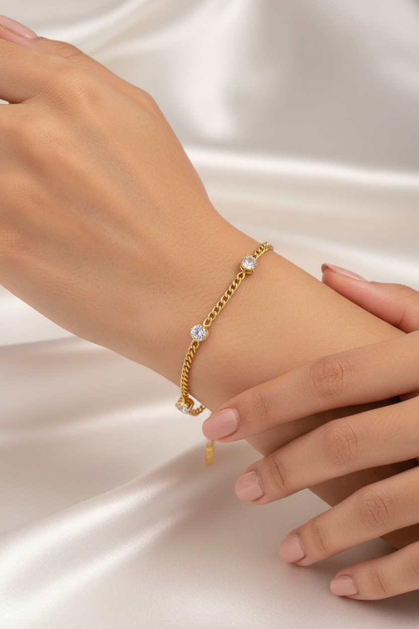 Gold curb crystal bracelet on wrist