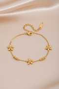 Gold flower bracelet champagne background
