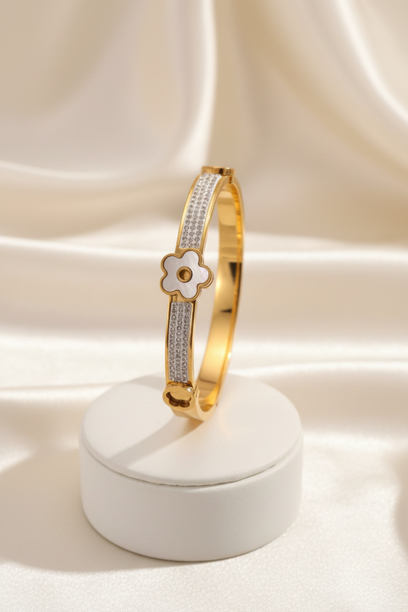 Gold pave clover bangle on stand