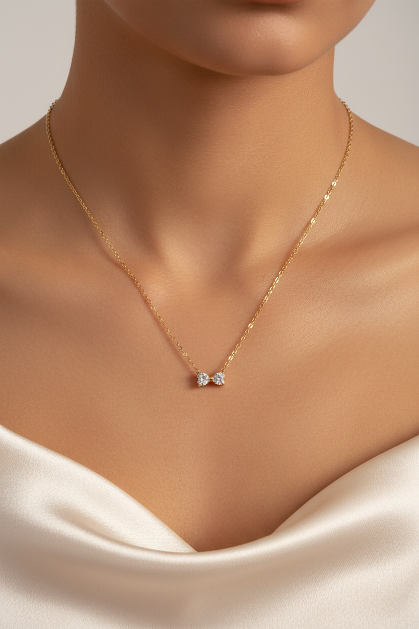 Tiny gold bow necklace on neck